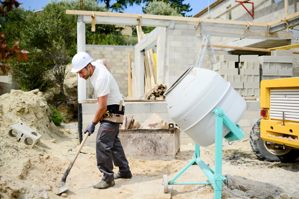 Portrait Of Handsome Construction Worker On Building Industry Construction Site