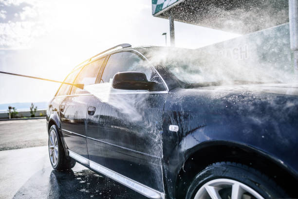 High Pressure Washing Car Outdoors. Car Washing Under The Open Sky.