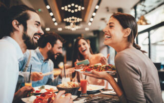 Group Of Happy Friends Having Breakfast In The Restaurant