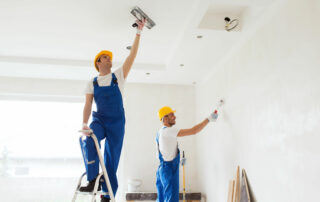 Group Of Builders With Tools Indoors