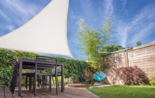 Modern House Terrace In Summer With Table And Shade Sail